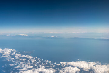 Fototapeta premium view from the airplane window landscape above the clouds