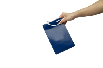Hand holding blue shopping bag isolated on white background with clipping path.