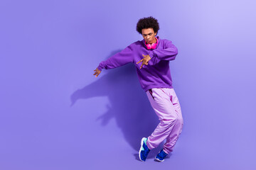 Full size photo of stylish positive person wear violet hoodie pants dancing modern hip hop music...