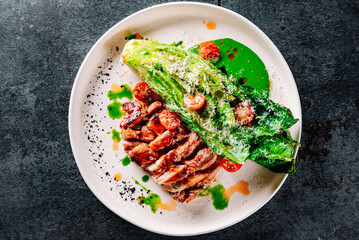 chicken grill meat served with pak choi vegetables on plate