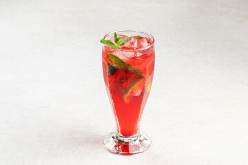 Glass of fresh fruit lemonade with ice and mint
