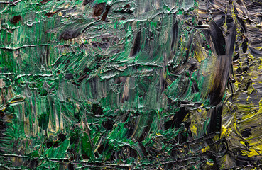 Grungy background of green,yellow and black oil paint.