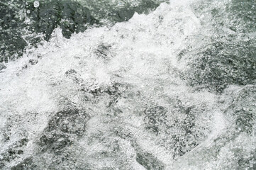 Water flowing in nature. Close up of te river water. 