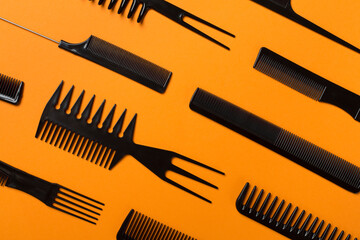 Professional combs and hairdresser tools on color background, top view