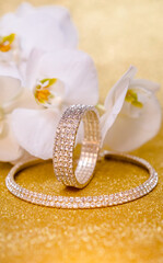 Bracelet and necklace on a gold shiny background
