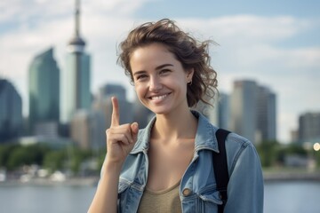 Medium shot portrait photography of a glad girl in her 30s showing ok gesture against a city skyline background. With generative AI technology
