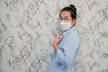 elegant womanman wearing a mouth protection to prevent getting sick at work or on the way to work  isolated on White background, pandemic and social distancing concept.Covid-19