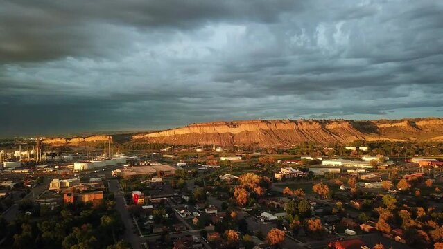 Aerial Shot Of City By Cliff Against Cloudy Sky At Sunset, Drone Flying Forward Over Buildings - Billings, Montana