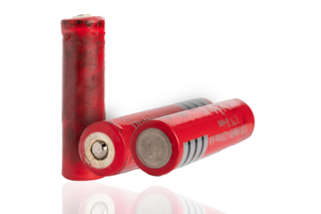 Different alkaline batteries standing on white surface, Macro shot