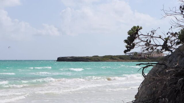 Beautiful view of the ocean.Landscape with incoming waves and coastal cliffs.Small waves wash the sandy shore. Tides, ebbs and sea level rise due to global warming.Atlantic Ocean coast in Cuba