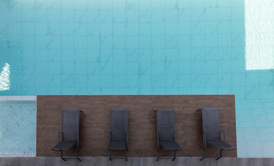 A top view from a swimming pool, with wood chair