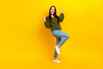 Fototapeta na wymiar Full length photo of funky lucky lady wear khaki pullover rising fists screaming isolated yellow color background