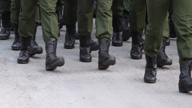Soldier military boots run close up. Many male legs step. A lot of army man walk. 9 may victory parade. Green war uniform. Foot shoes. Militant platoon march. Armed officer troop went. Combat brigade.