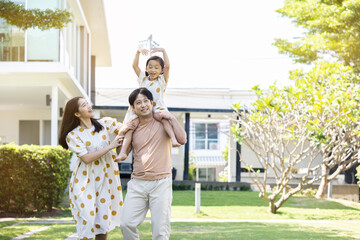 asian family Parents and daughters doing a happy walk in the village garden. During the holidays weekends to relax. friendship and living together. member health care. Concept health insurance