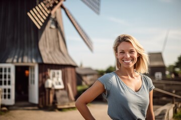 Lifestyle portrait photography of a glad girl in her 30s with thumbs up against a rustic windmill background. With generative AI technology