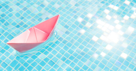 Voyage. Floating pink paper boat water pool abstract ship symbol. Blue water travel abstract boat travel concept paper ship origami boat toy paper sailboat. Dream tours concept dream travel background