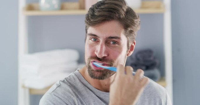 Dental, face and man brushing teeth with toothbrush in a bathroom for hygiene, wellness and fresh breath. Oral care, mouth and portrait of male cleaning tooth and gums with toothpaste in his home
