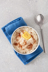 rice pudding with butter cinnamon. french riz au lait, norwegian risgrot, traditional breakfast dessert