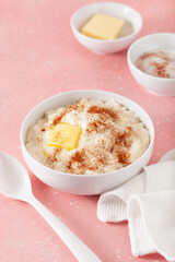 rice pudding with butter cinnamon. french riz au lait, norwegian risgrot, traditional breakfast dessert