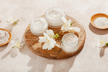 Fototapeta na wymiar skincare products and jasmine flowers. natural cosmetics for home spa treatment