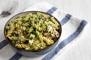 Homemade Chicken Spinach Alfredo Rotini Pasta in a Bowl, side view.