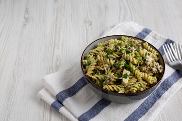 Homemade Chicken Spinach Alfredo Rotini Pasta in a Bowl, side view. Copy space.