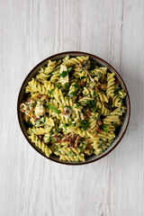 Homemade Chicken Spinach Alfredo Rotini Pasta in a Bowl, top view. Flat lay, overhead, from above.