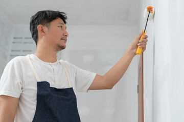 painter man, brush in hand for products to restore and paint the wall, indoor the building site of a house, wall during painting, renovation, painting, contractor, Architect, construction worker