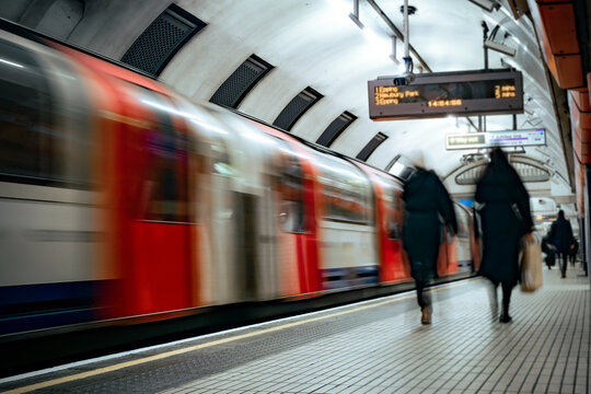 Motion blurred view of London train in motion on platform 