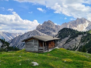 Fototapeta na wymiar Traditional alpine cabin, Dolomites, South Tyrol, Italian Alps, Prags. An old wooden hut in the mountains. Mountain cabin. 