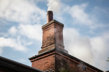 close-up of chimney, with smoke rising from the top, created with generative ai