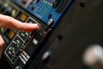 Sound Engineer Using Digital Audio Mixer Sliders Engineer Pressing Power Button Control Panel Recording Studio Technician Close-up