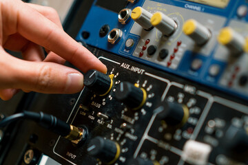 Sound engineer using digital audio mixer sliders Engineer pressing keys adds control panel volume Recording studio technician close up