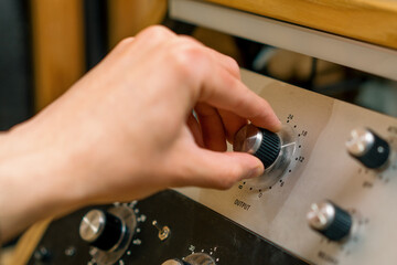Sound engineer using digital audio mixer sliders Engineer pressing keys adds control panel volume...