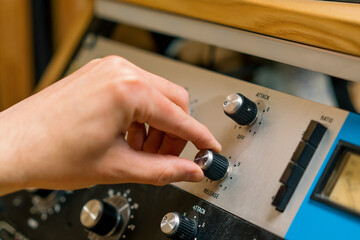 Sound engineer using digital audio mixer sliders Engineer pressing keys adds control panel volume Recording studio technician close up