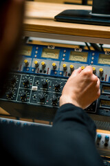 Sound engineer used digital audio mixer Sliders Engineer presses key Control panel Recording studio technician close-up