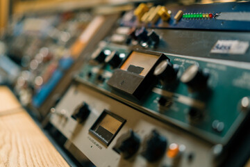 old displays of professional analog volume meters in a recording studio measuring and showing decibels close-up