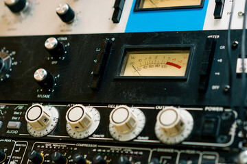 old displays of professional analog volume meters in a recording studio measuring and showing decibels close-up