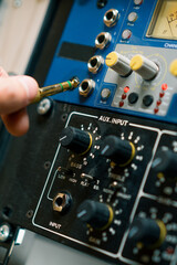 Fototapeta na wymiar sound engineer connects Audio cable Professional wires with connectors to music equipment recording studio