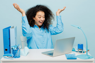 Young winner overjoyed successful employee IT business woman wear casual shirt sit work at white...