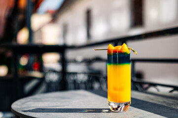 Fresh cold mango cocktail, mango juice smoothie in glass outdoors - obrazy, fototapety, plakaty