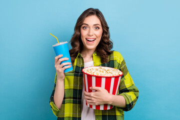 Obraz premium Photo of funky impressed woman dressed plaid shirt watching interesting movie eating pop corn drinking soda isolated blue color background