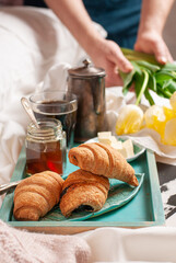 Spring breakfast in bed: croissants, coffee, honey and flowers. Close up - 611049674