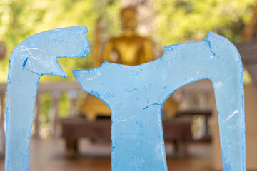 A broken plastic chair in a Buddhist temple, Thailand