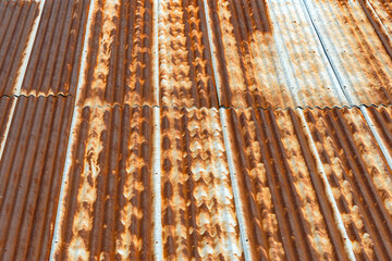 Artistic of old and rusty zinc sheet roof. Vintage style metal sheet roof texture. Pattern of old metal sheet. Rusting metal or siding. Corrosion of galvanized. Background and texture in retro concept