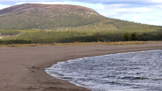 Arjeplog, Sweden Freshwater lapping up onto a small beach on the Hornavan Lake.