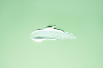 White Cream Smear on Green Background