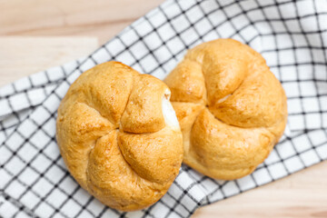 Kaiser rolls with napkin on table, closeup