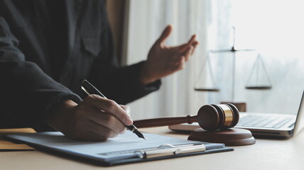 Business and lawyers discussing contract papers with brass scale on desk in office. Law, legal...