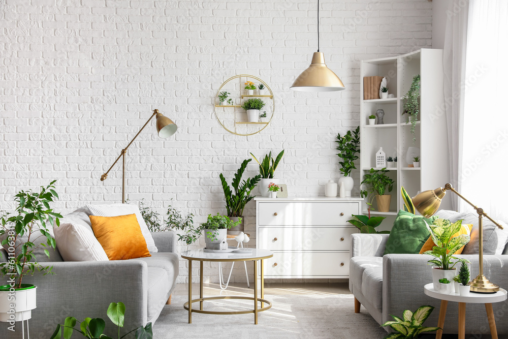 Wall mural Interior of living room with sofas, tables and houseplants